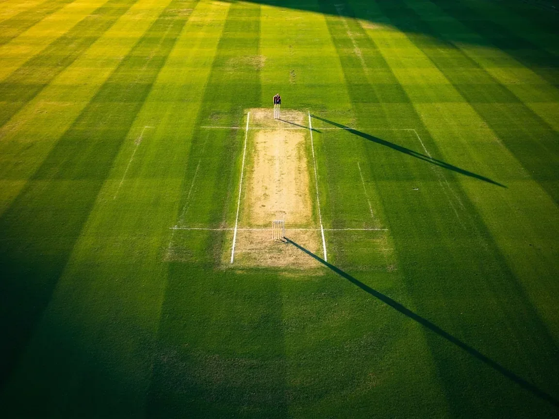 Aerial view of an Indian cricket oval with the mega contest tile grid laid out over the pitch area